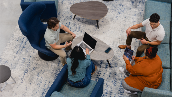 Diverse group of business professionals sitting around table and discussing ideas for project development and future success.