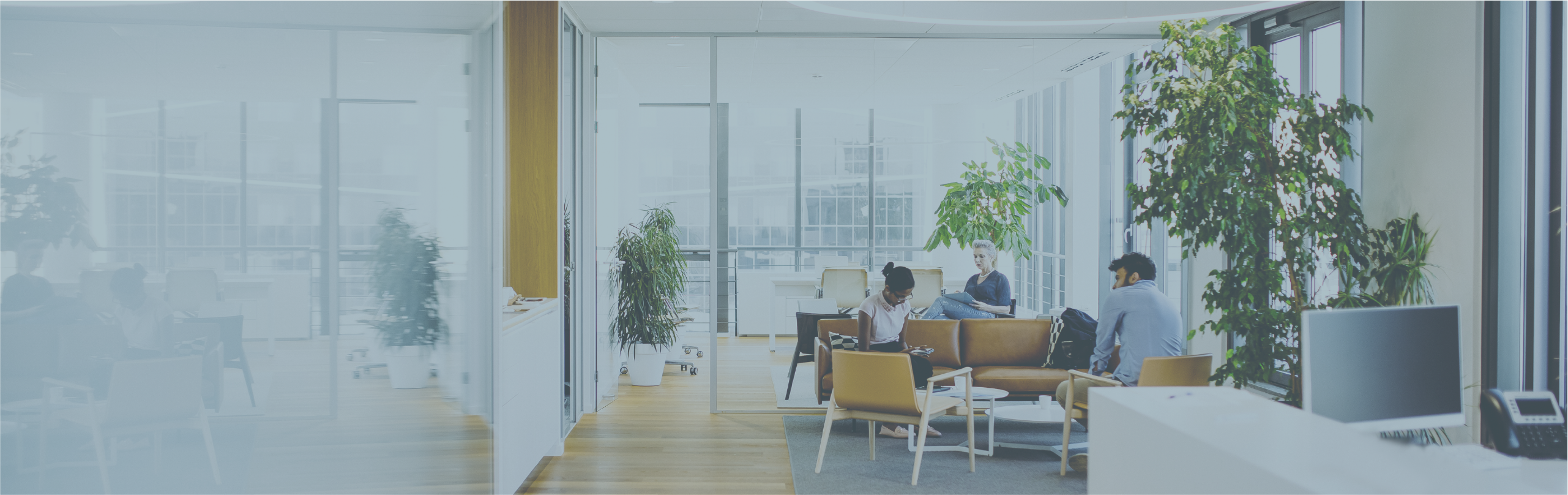 Business people sitting in modern business office lobby.