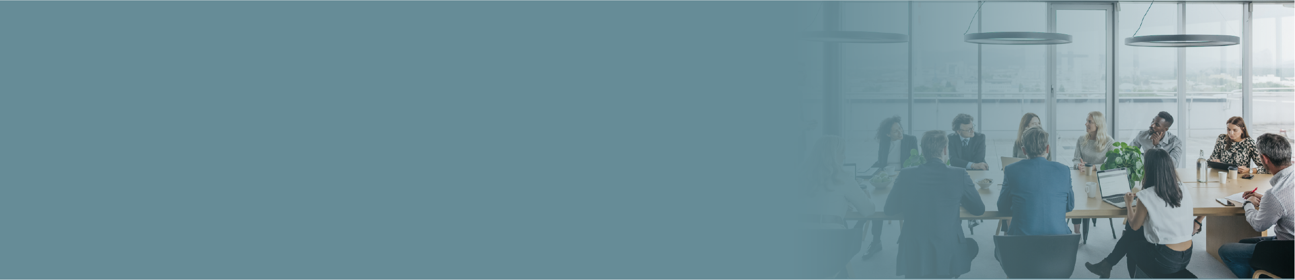 Blue banner fading into an modern office meeting image.